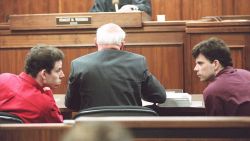LOS ANGELES, UNITED STATES: This 02 February 1995 file picture shows Erik (L) and Lyle (R) Menendez conversing in the courtroom during a hearing in Los Angeles. The Menendez brothers were sentenced to life in prison without the possibility of parole 17 April for the murder of their parents. AFP PHOTO FILES/Kim KULISH (Photo credit should read KIM KULISH/AFP via Getty Images)