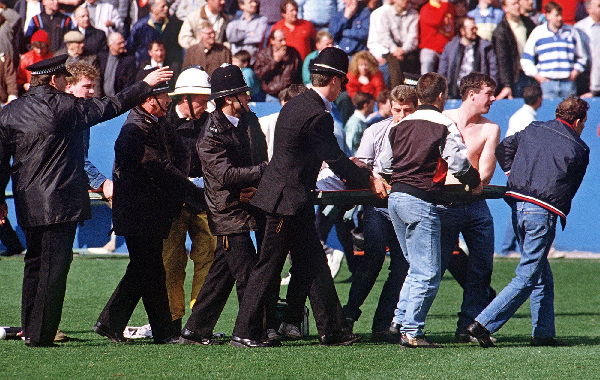 An injured supporter is carried away during the Hillsborough disaster in 1989.