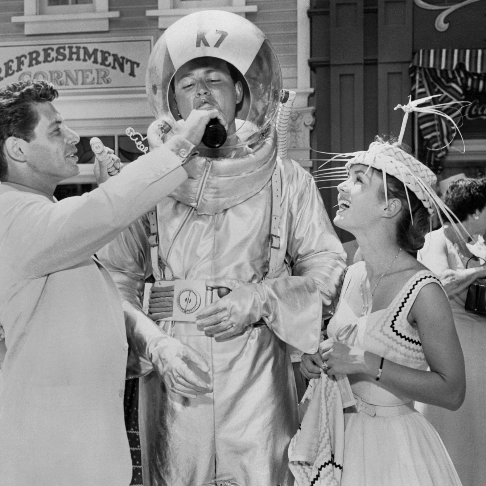 Opening day co-host Eddie Fisher, a famous singer and actor, serves a drink to Don MacDonald as actress Debbie Reynolds looks on. Fisher and Reynolds married that year.