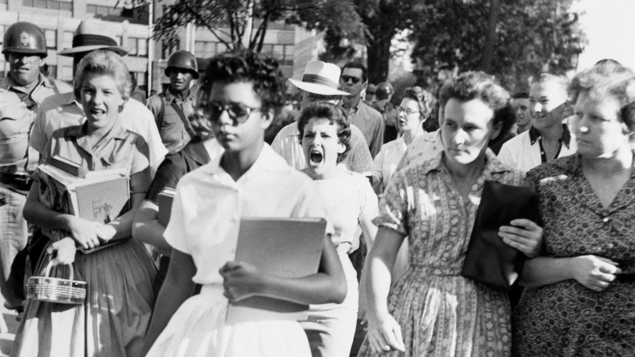 Elizabeth Eckford, one of nine Black students whose integration into Little Rock's Central High School was ordered by a federal court following legal action by the National Association for the Advancement of Colored People, ignores the hostile screams and stares of white students on her first day of school, 6th September 1957.