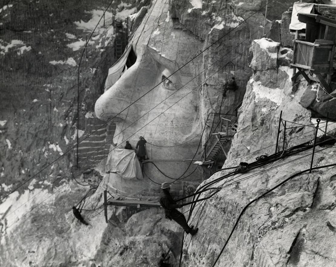 Men work on the face of Jefferson at Mount Rushmore in South Dakota, during the 1940s.