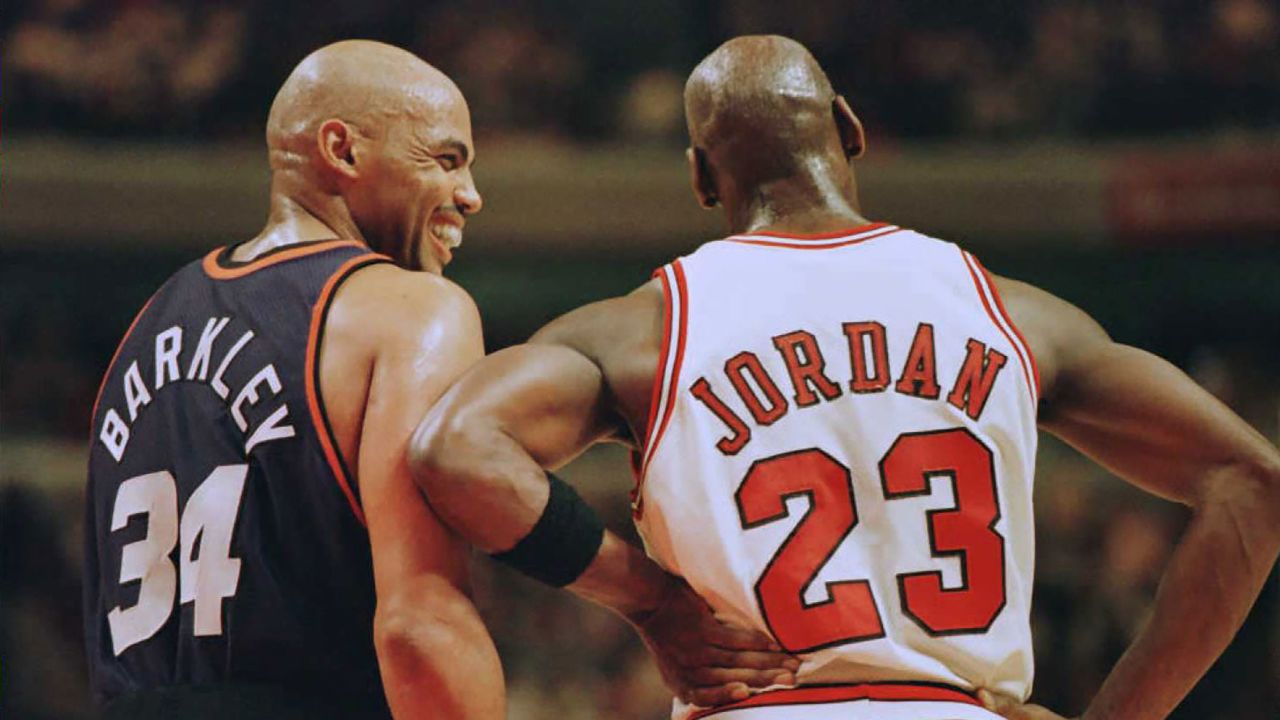 Phoenix Suns forward Charles Barkley (34) laughs at a foul call with Chicago Bulls guard Michael Jordan (23) in the first half 28 January 1996 at the United Center in Chicago.