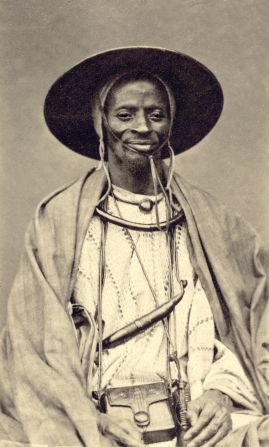 From the mid-19th century, elite Senegalese commissioned photograph portraits, such this one, a copy of which was handed to Belgian explorer Adolphe Burdo in 1878, by a man Burdo called the “King of Dakar.” The modernity shown by this African shocked Burdo so much that he<strong> </strong>quickly left the city, writes Paoletti.