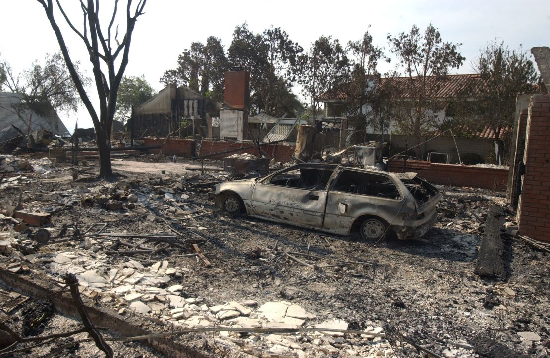 Burned-out cars and the shells of homes are all that remain in the Scripps Ranch neighborhood of San Diego after the Cedar Fire tore though the area. (Photo by Ramin Talaie/Corbis via Getty Images)