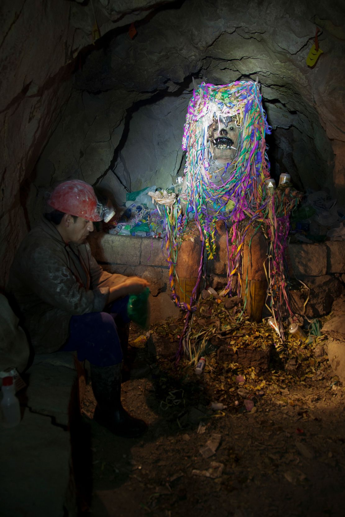 The effigy pictured is El Tío, revered as the lord of the underworld. Miners offer gifts of cigarettes, coca leaves and alcohol, the remnants of which can be seen all around him.