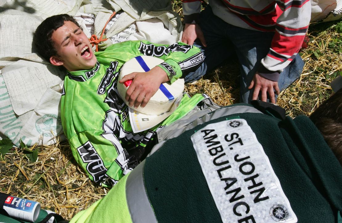 Chris Anderson holds his cheese as he receives medical attention following a 2005 race. He won but suffered a broken ankle.