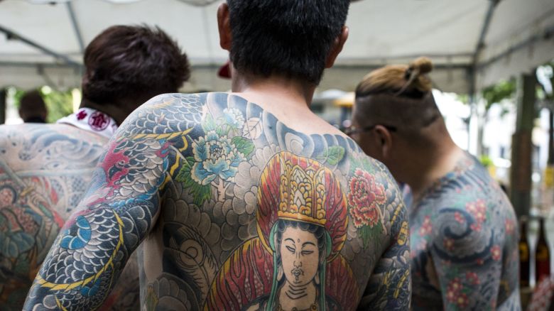 TOKYO, JAPAN - MAY 14: Yakuza members proudly display their tattoos during the second day of the Sanja Matsuri Festival in Tokyo's Asakusa district on May 14, 2016. This festival is one of the rare times when members of the notorious Yakuza gang reveal themselves to public and take photo with festival goers.

                                                                             (Photo by Richard Atrero de Guzman/Anadolu Agency/Getty Images)