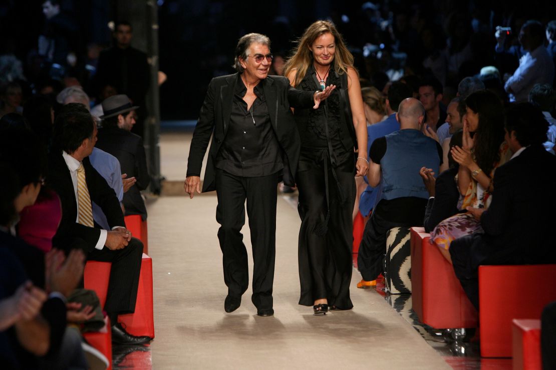 Roberto Cavalli walks the runway (accompanied by his then-wife Eva Marie) during his label's Spring-Summer 2008 menswear show during Milan Fashion Week.