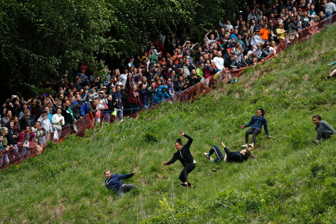 Spectators watch competitors tumble down Cooper's Hill.
