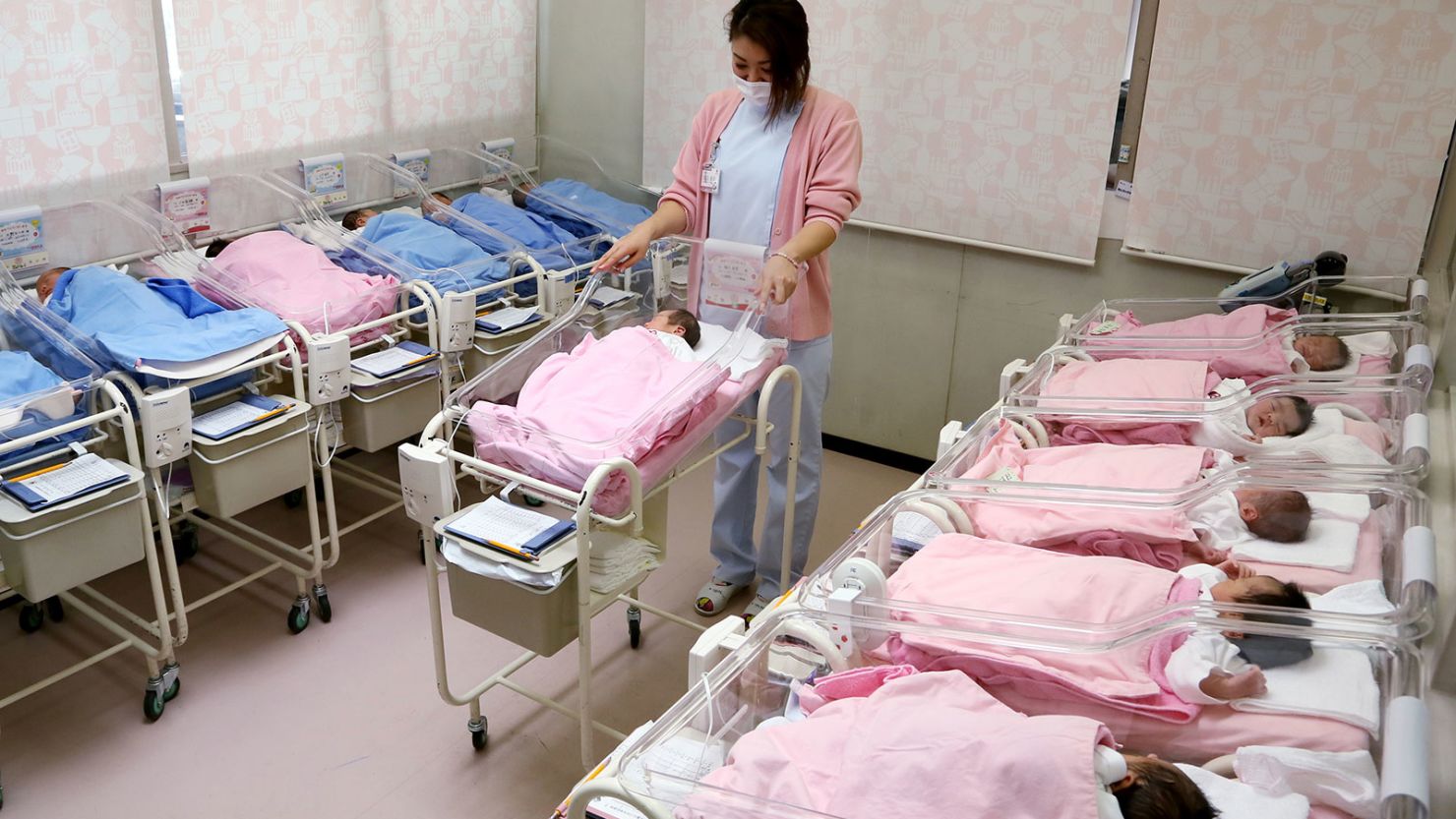 Hospital staff attend to babies in the nursery ward in Misato city, Saitama prefecture, Japan.