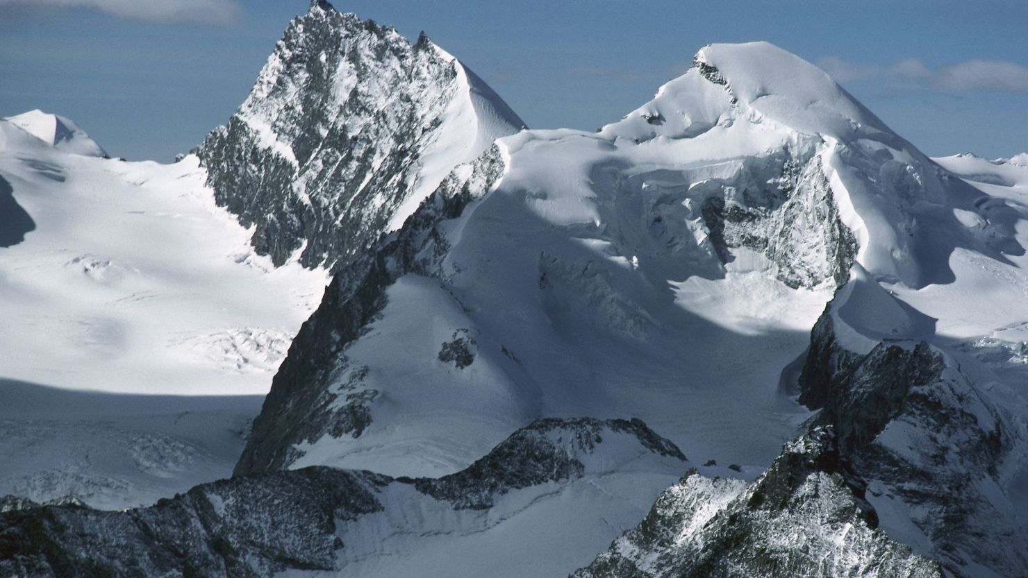 The snow-capped peaks of Rimpfischhorn (left) and Allalinhorn in the Valais Alps, Switzerland.