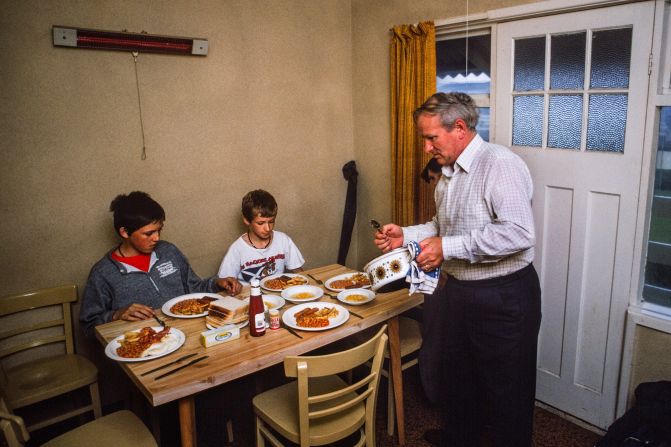 <strong>What a treat: </strong>A family tucks into plates of fried breakfast ingredients while on vacation at a holiday camp in Britain in the 1980s.