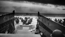 US Troops wading through water after reaching Normandy and landing Omaha beach on D Day, 1944.