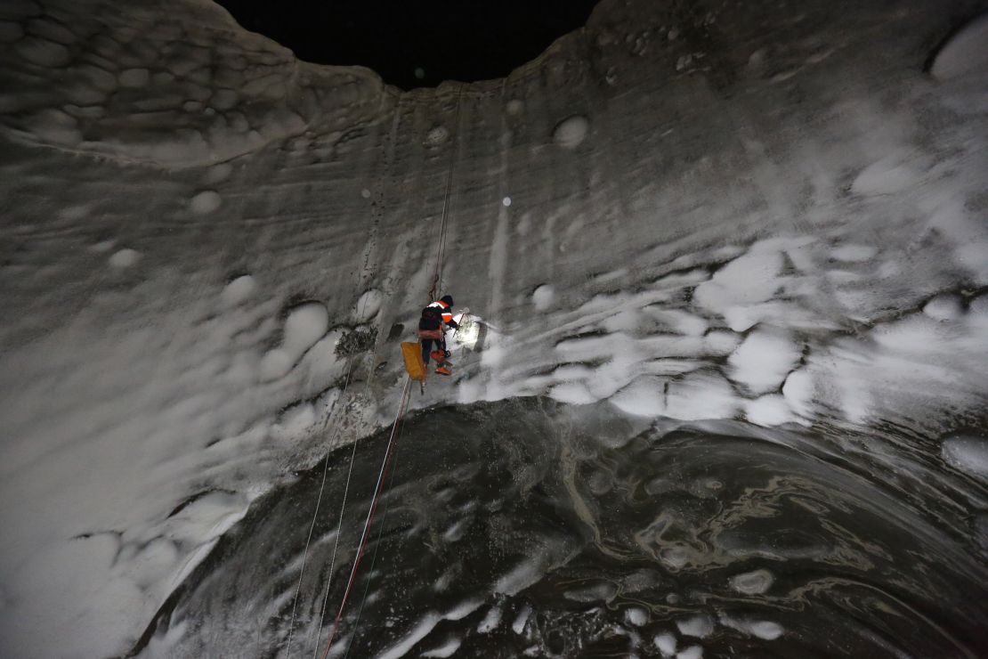 A scientist exploring a crater on the Yamal Peninsula on November 8, 2014. Russian researchers have made field trips to the craters to collect data in an effort to solve the mystery of their existence.