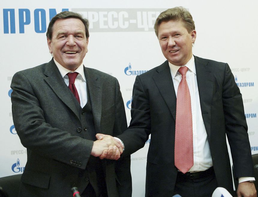 Former German Chancellor Gerhard Schröder and Gazprom CEO Alexei Miller (Republican) shake hands during a press conference for Russian natural gas monopoly Gazprom at its headquarters in Moscow, Russia, on March 30, 2006. 