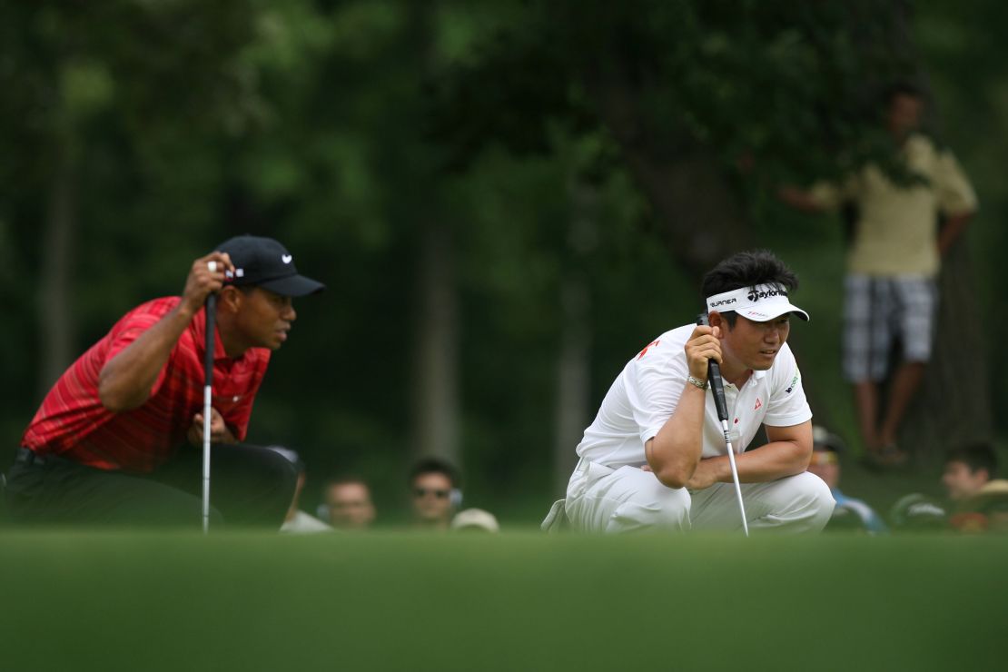 Woods and Yang eye up their putts during the final round.