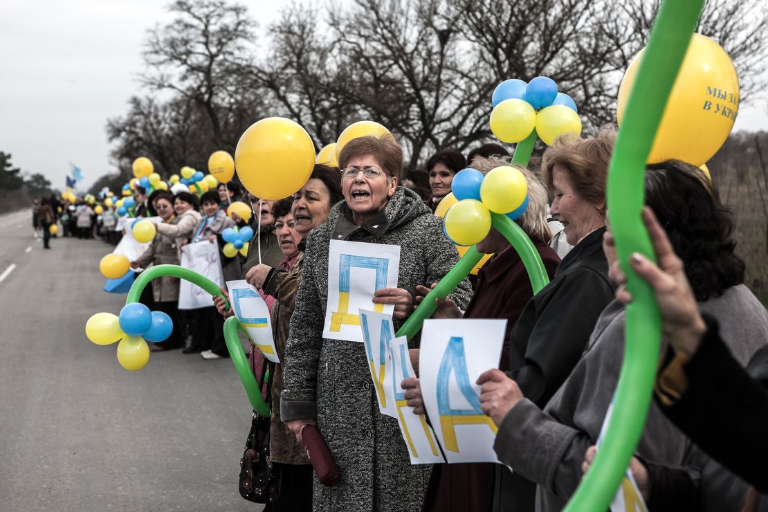 Crimean Tatar women rallying against the war between Russia and Ukraine on the road between Simferopol and Sevastopol in Crimea, Ukraine, on March 8, 2014.