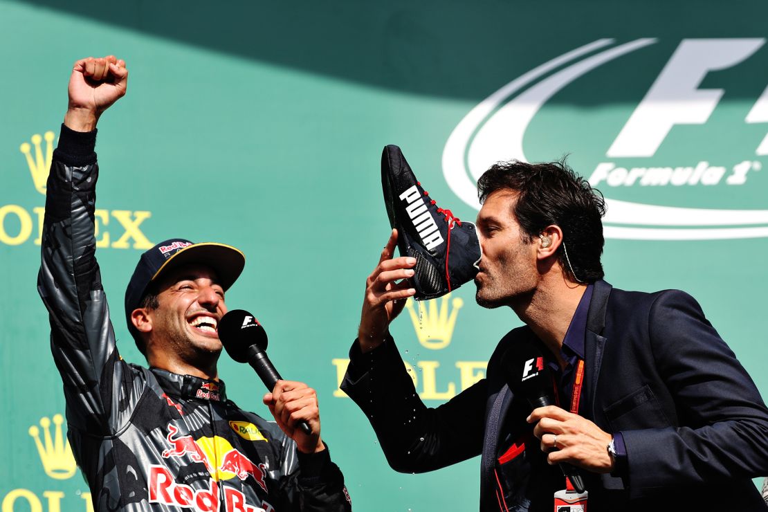 Australian former F1 driver Mark Webber partakes in Ricciardo's infamous 'Shoey' celebration, drinking champagne out of Ricciardo's race boot.