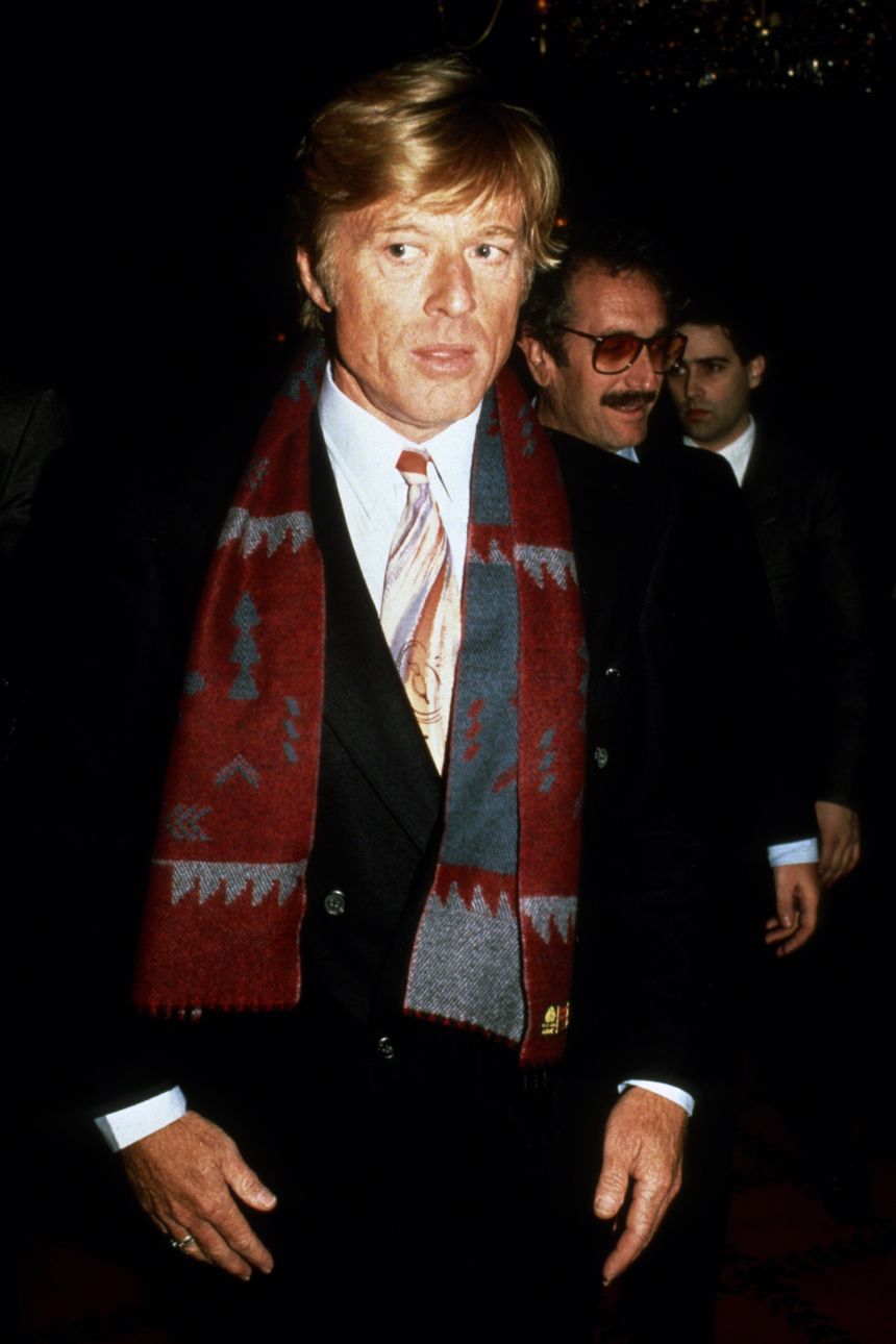 Redford infused black tie dress codes with personality through patterned ties and woven scarves.