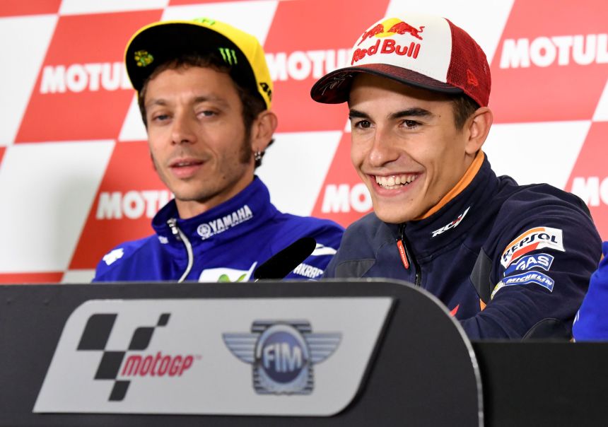 Márquez smiles beside the legendary Valentino Rossi during a press conference at the Japanese Grand Prix on October 13, 2016.