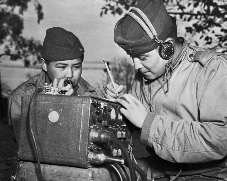 A two-man team of Code Talkers relays orders during World War II.