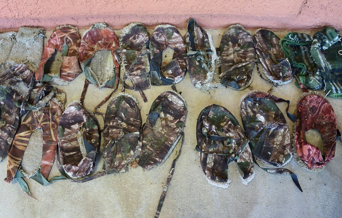 Shoes left behind by migrants on the Chiltons' ranch are displayed on their front porch in 2016.