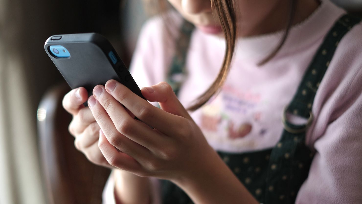 Child with a smartphone. Federal District Judge Algenon Marbley blocked Ohio legislation that would require social media platforms to obtain parental consent for children under 16 to create an account.