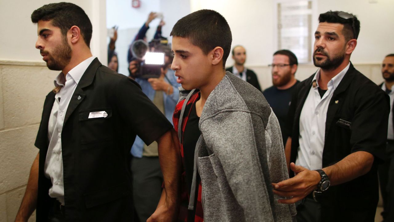 Ahmed Manasra (C), a 14-year old Palestinian boy, convicted of the attempted murder of two Israelis in a stabbing in October 2015, leaves the District Court in Jerusalem after his sentencing hearing on November 7, 2016.
The court sentenced Manasra to 12 years in jail for the knife attack, his lawyer said. / AFP / AHMAD GHARABLI        (Photo credit should read AHMAD GHARABLI/AFP via Getty Images)