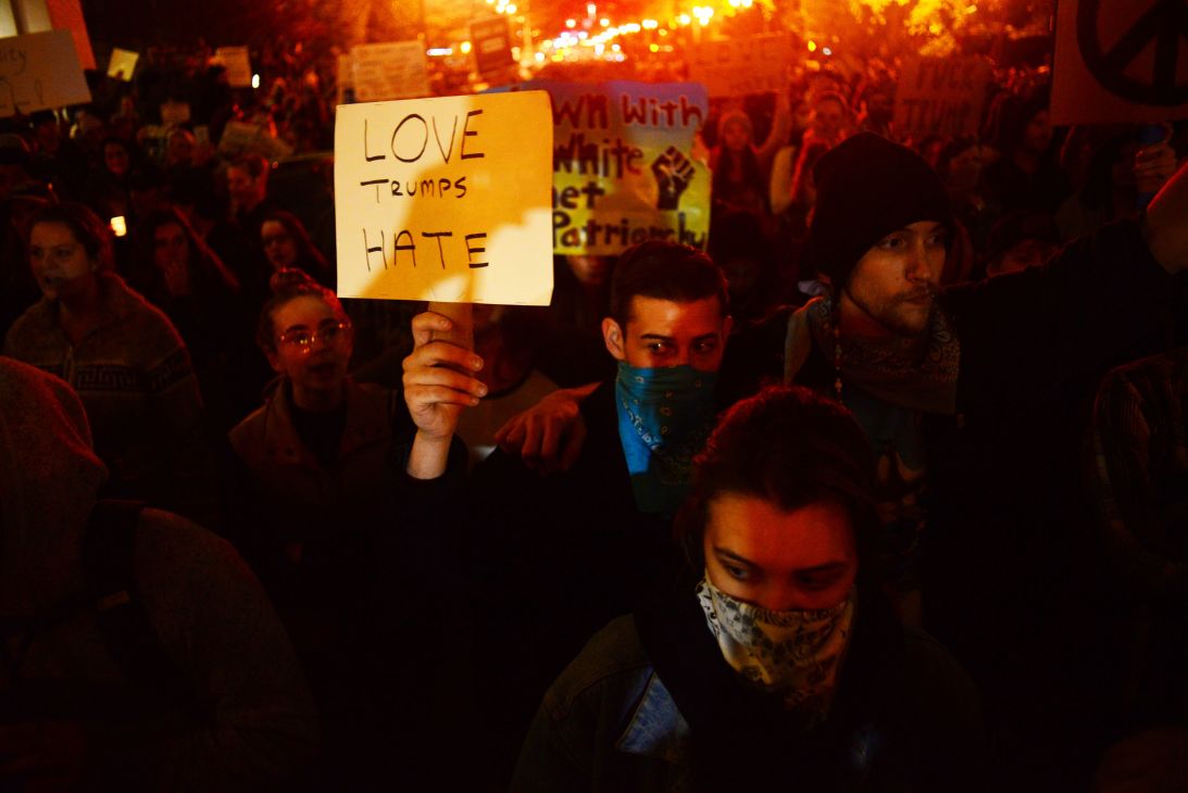 A demonstrator holds up a sign during a November 11, 2016, protest against Donald Trump's presidential election victory, in Portland .