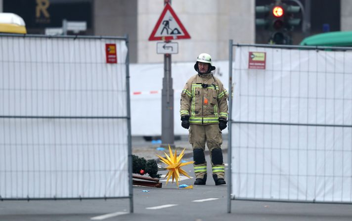 A rescue worker stands beside Christmas decorations that were scattered by the crash.