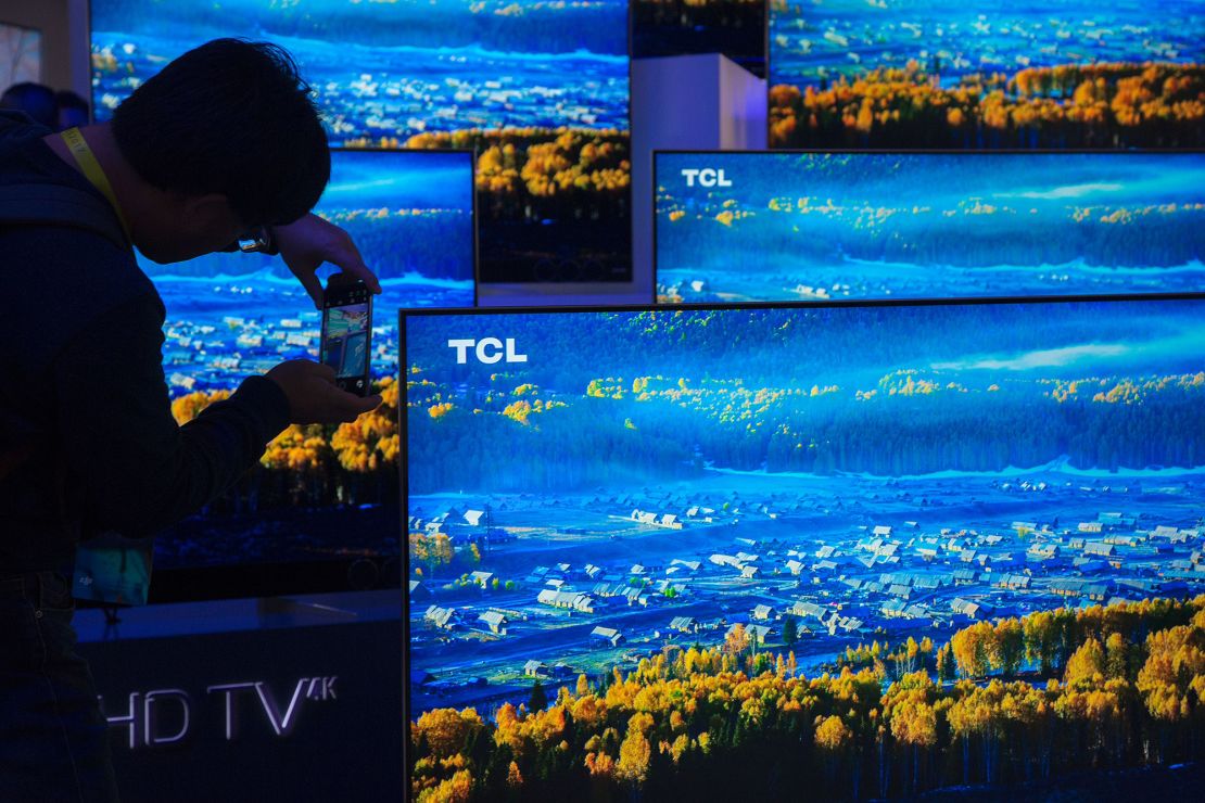 A man photographs TCL 4K UHD TVs during the 2017 Consumer Electronic Show (CES) at the Las Vegas Convention Center in Las Vegas, Nevada, January 5, 2017.