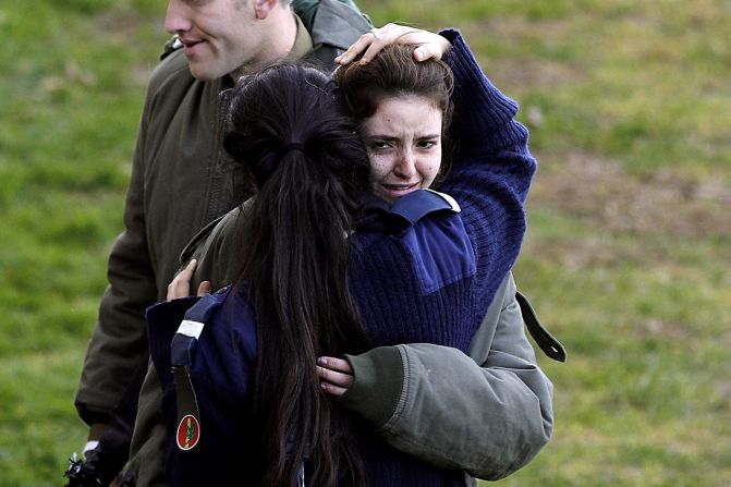 A distraught Israeli soldier is consoled at the site of Sunday's attack.