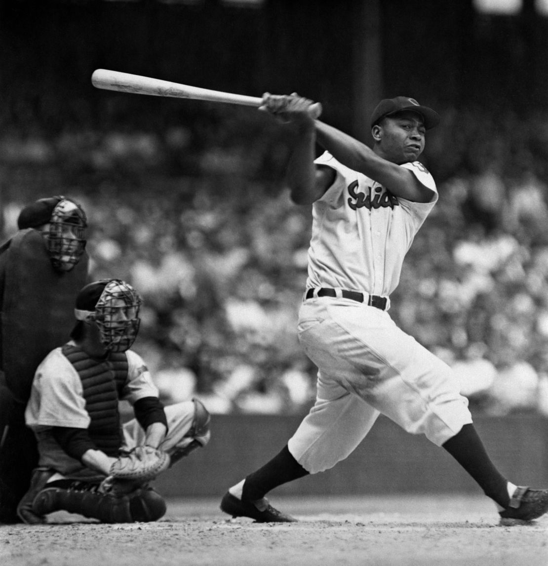 Larry Doby, center fielder of the Cleveland Indians, hits a home run in his second season in 1948.