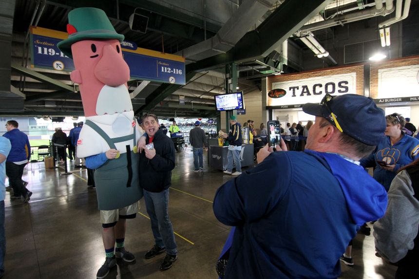 A fan gets a picture with one of the racing sausages in 2017.