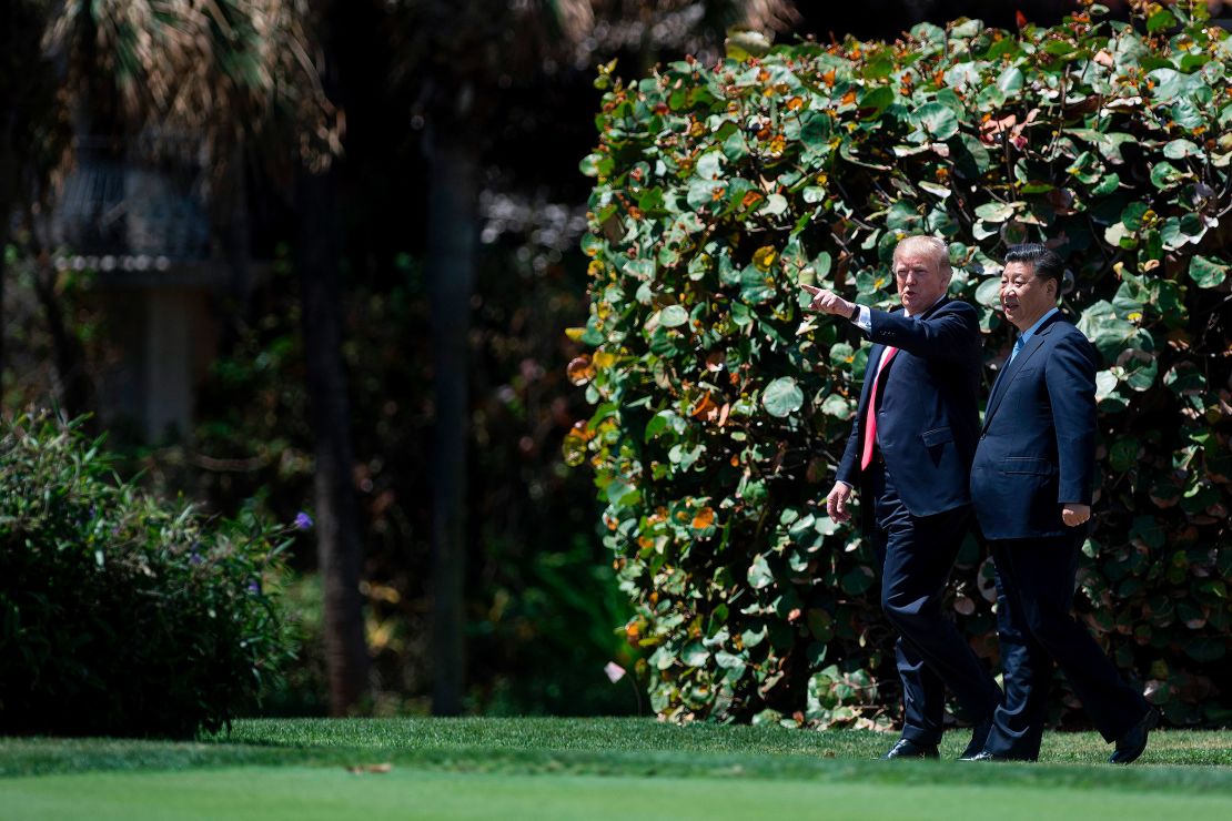 US President Donald Trump and Chinese President Xi Jinping walk together at the Mar-a-Lago estate in Florida on April 7, 2017.