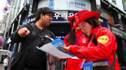 South Korean tourist information helpers (red) guide tourists in the popular Myeongdong shopping district in Seoul on April 25, 2017.
South Korea's tourist industry has been hammered by China's boycott over the deployment of US missile defence system, with visitor numbers from the Asian giant plummeting 40 percent in March, statistics showed. / AFP PHOTO / JUNG Yeon-Je        (Photo credit should read JUNG YEON-JE/AFP via Getty Images)