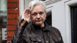Julian Assange gestures while speaking to the media from the balcony of the Ecuadorian Embassy on May 19, 2017 in London.