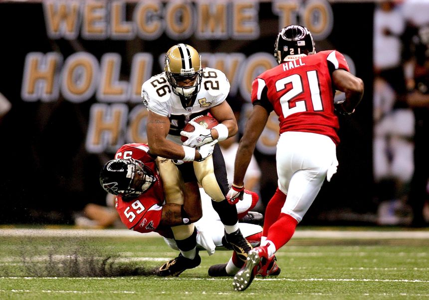Deuce McAllister is taken down by Atlanta Falcons linebacker Michael Boley during the first NFL game back at the Superdome.