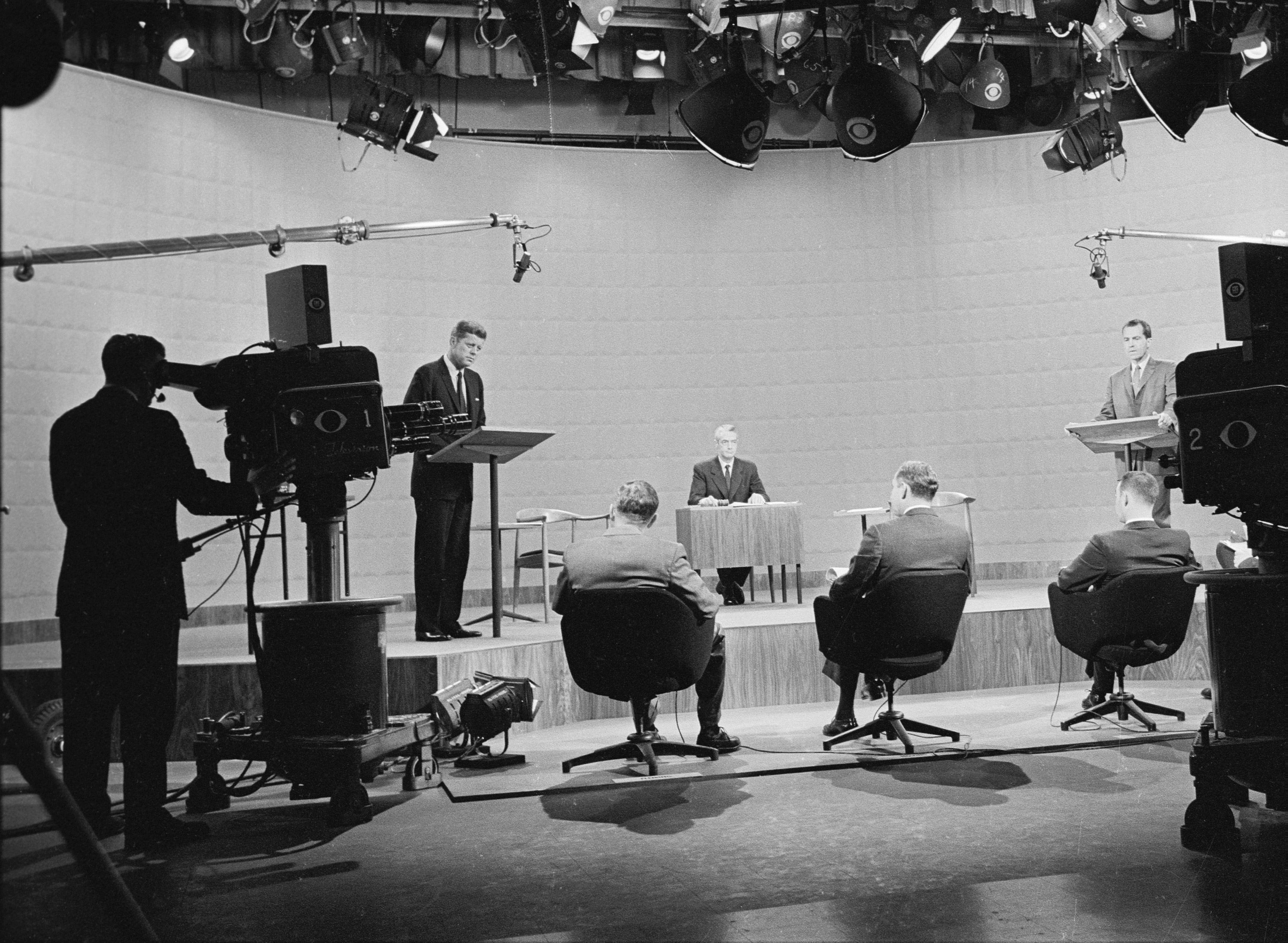 John F. Kennedy, left, speaks during his first presidential debate with Vice President Richard Nixon in 1960. The one-hour debate was moderated by news anchor Howard K. Smith. It started with eight-minute opening statements and then moved on to alternating questions from panelists, seen here in the foreground.