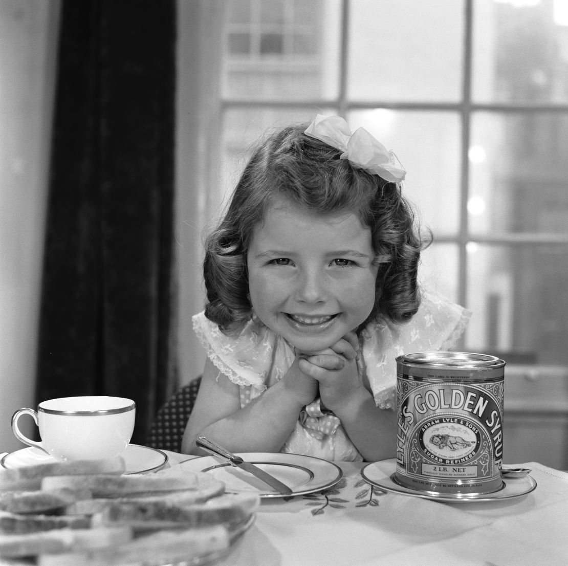 The product has been a staple in the pantries of British bakers since it's inception. Above, a young girl about to spread the syrup on bread in 1957.