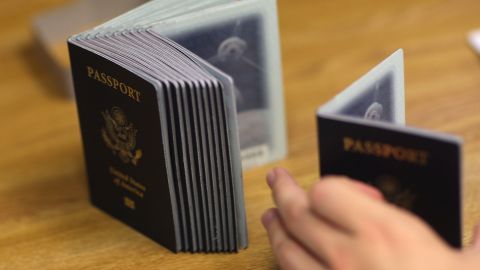 MIAMI - JUNE 22:  A Passport Processing employee uses a stack of blank passports to print a new one at the Miami Passport Agency June 22, 2007 in Miami, Florida. The Bush administration postponed for at least six months a requirement that Americans who return to the United States by land or sea from Canada, Mexico and the Caribbean must carry passports. The rule, due to go into effect in January 2008, will be delayed until the summer of that year.  (Photo by Joe Raedle/Getty Images)