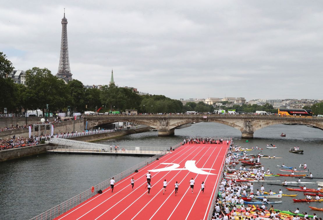 Athletes take part in a race on a runway set near the Alexander III bridge on the Seine in Paris on June 23, 2017.