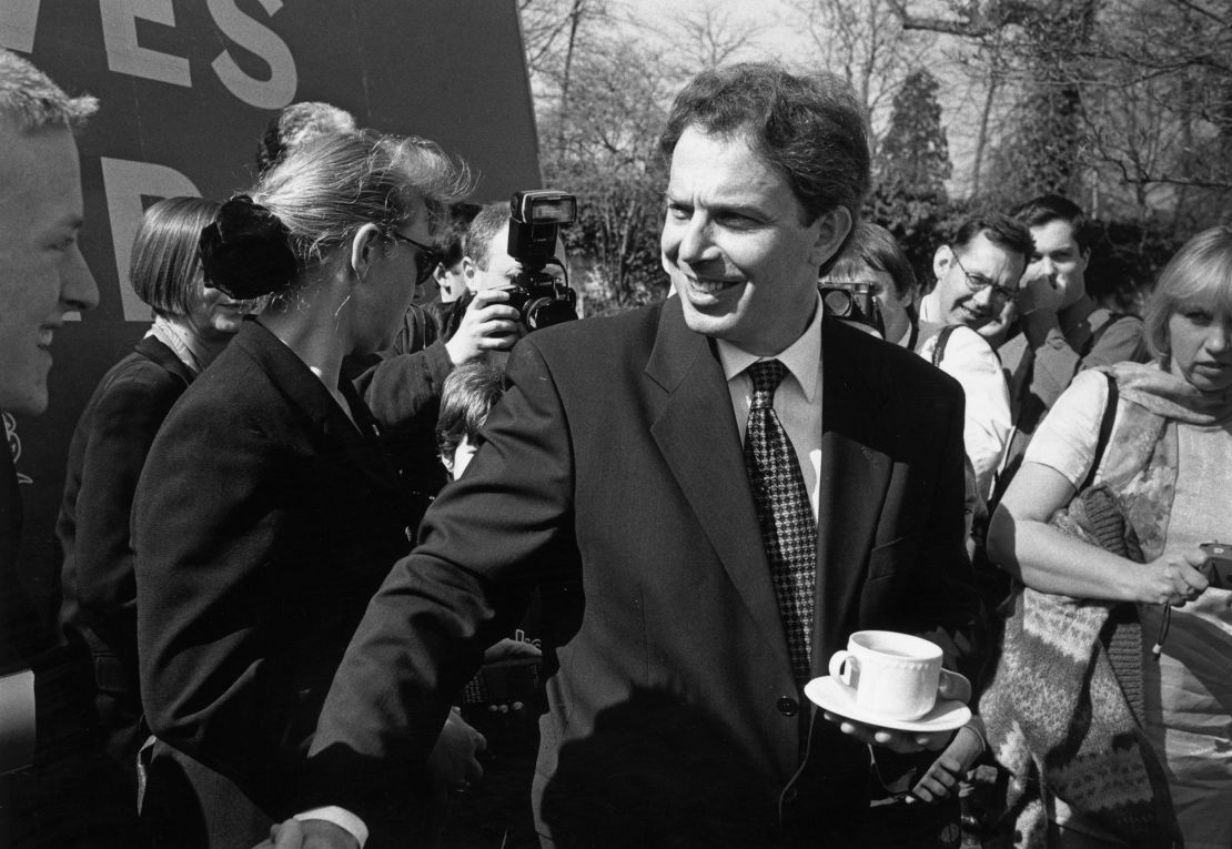 Tony Blair manages to balance tea and shake hands on the campaign trail in 1997. The Labour Party's election anthem was D:Ream club tune, "Things Can Only Get Better."