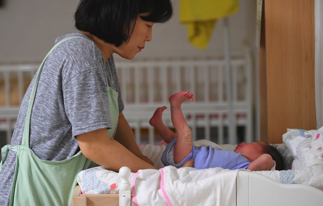 A social worker cares for a baby at the Jusarang Community Church in southern Seoul on May 24, 2017.