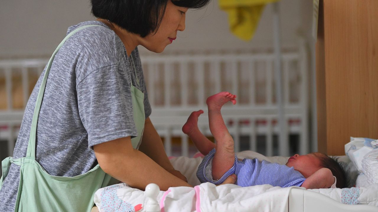 This photo taken on May 24, 2017 shows a social worker caring for a baby at the Jusarang Community Church in southern Seoul.