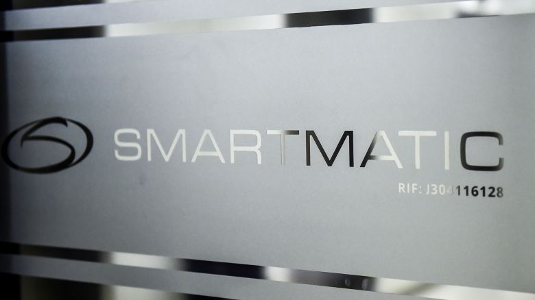 Picture of the logo of Smartmatic, the firm that supplies Venezuela's voting technology, seen on a sliding door at the headquarters of the company in Caracas, on August 2, 2017.