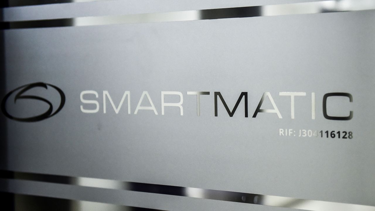 Picture of the logo of Smartmatic, the firm that supplies Venezuela's voting technology, seen on a sliding door at the headquarters of the company in Caracas, on August 2, 2017.