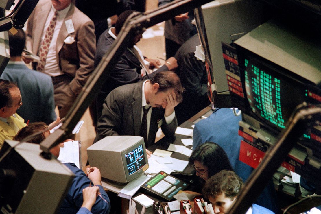 A trader (c) on the New York Stock Exchange reacts on October 19, 1987 as stocks are devastated during one of the most frantic days in the exchange's history.