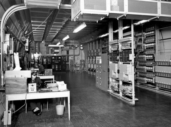 <strong>January 1957: </strong>Operators work on the power equipment and central apparatus racks in the telephone exchange.