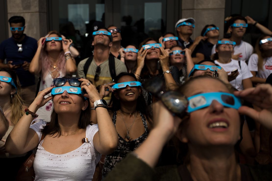 People view the solar eclipse at 'Top of the Rock' observatory at Rockefeller Center, August 21, 2017 in New York City.